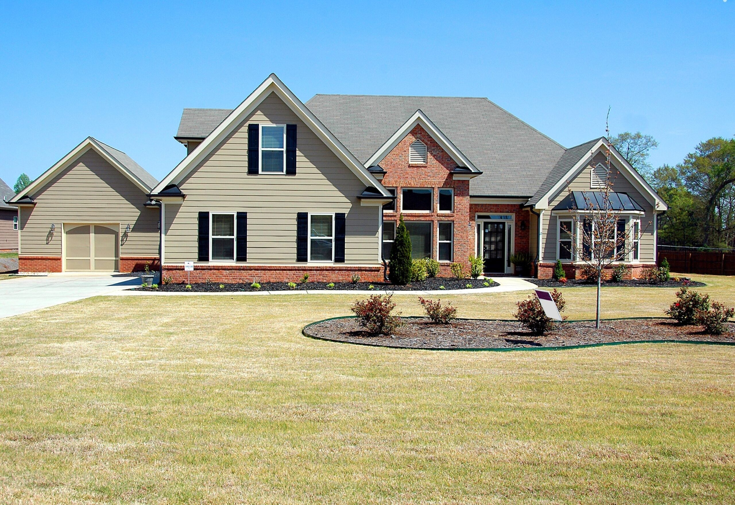 Exterior view of a modern one-story suburban home with a simple facade and well-maintained front yard—ideal for comfortable living.